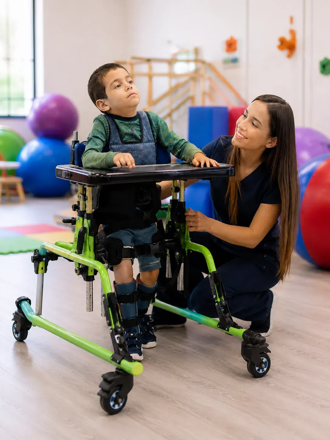 Cerebral palsy — child in a mobility frame with a supportive therapist