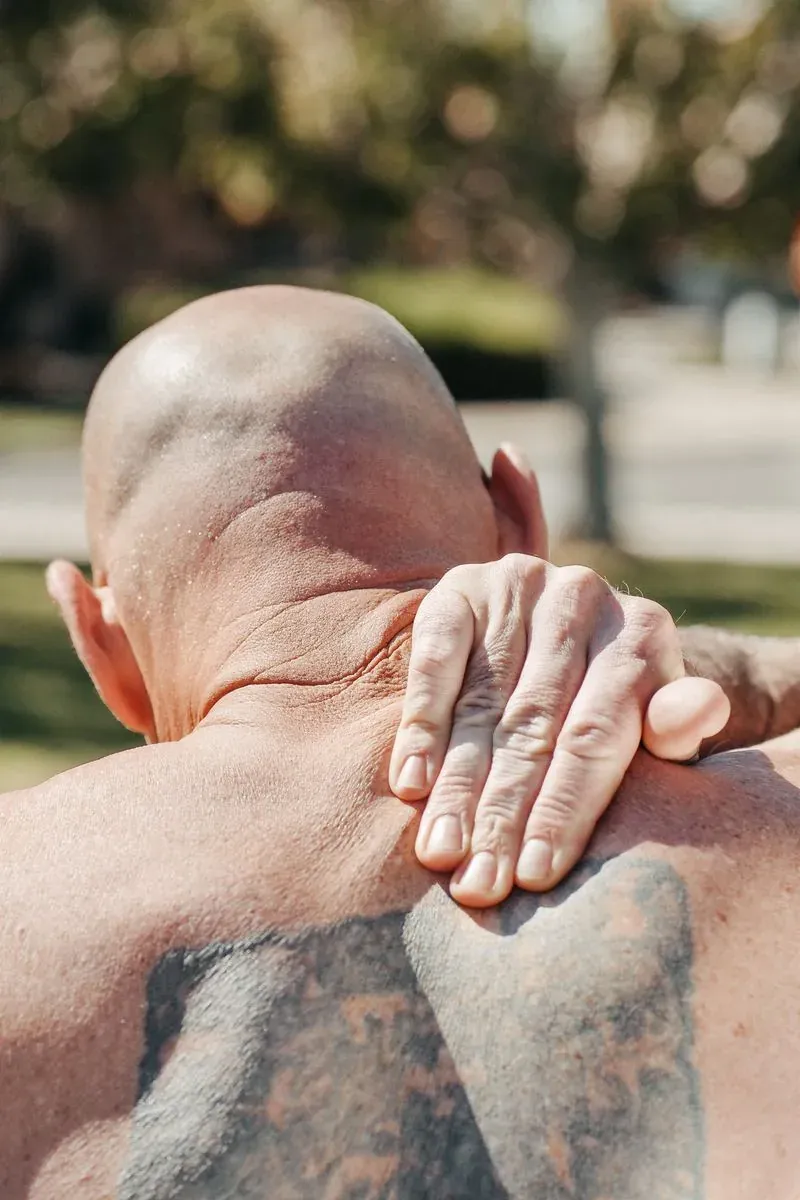 Shoulder pain relief in Utah — man holding a sore shoulder